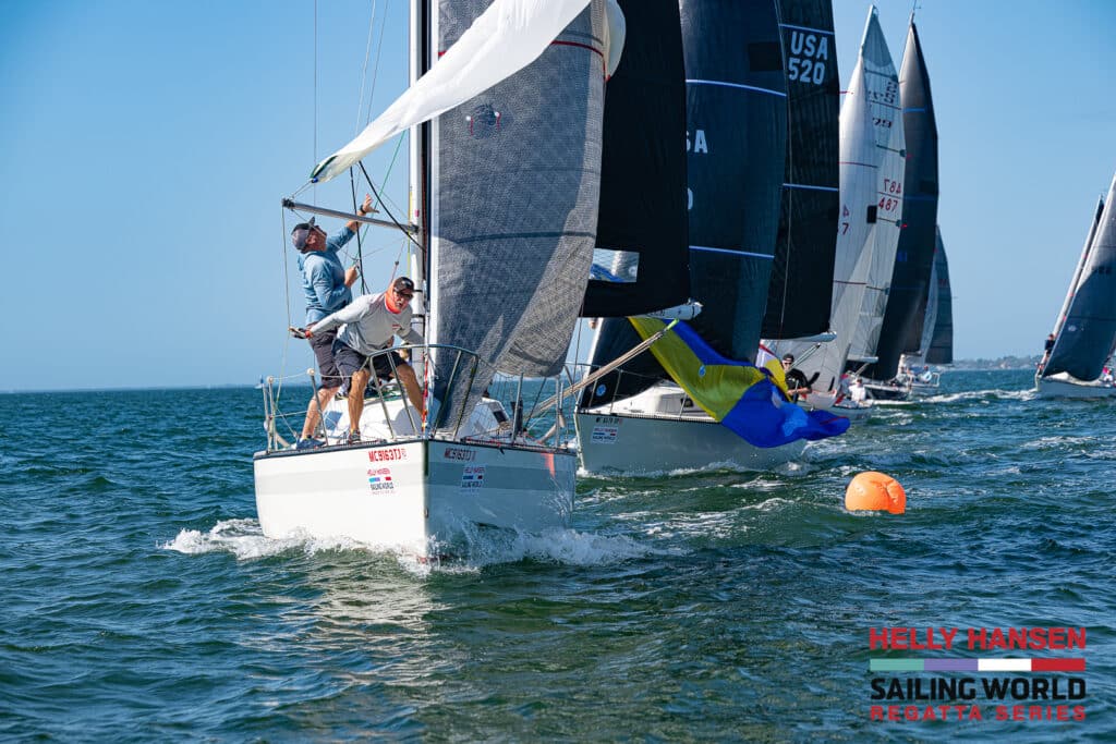 sailboats rounding a mark in florida with action on the foredeck