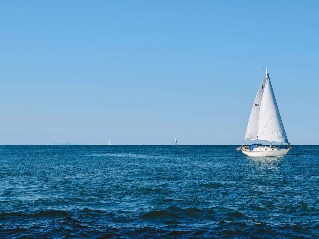 Sailboat floating in rippling sea